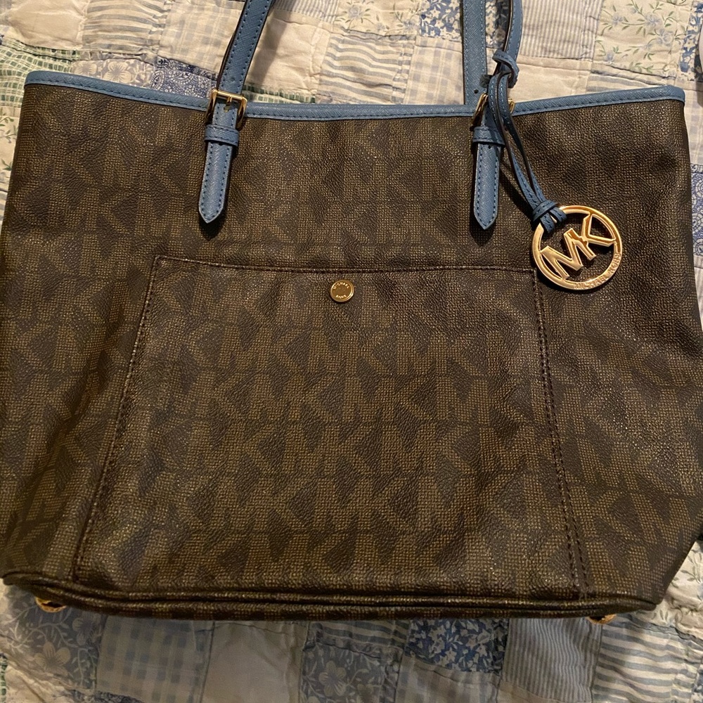 Michael Kors monogram bag w/ blue handles & trim.